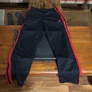 Nike black and red sweatpants with pockets small spot on the back shown in pics
